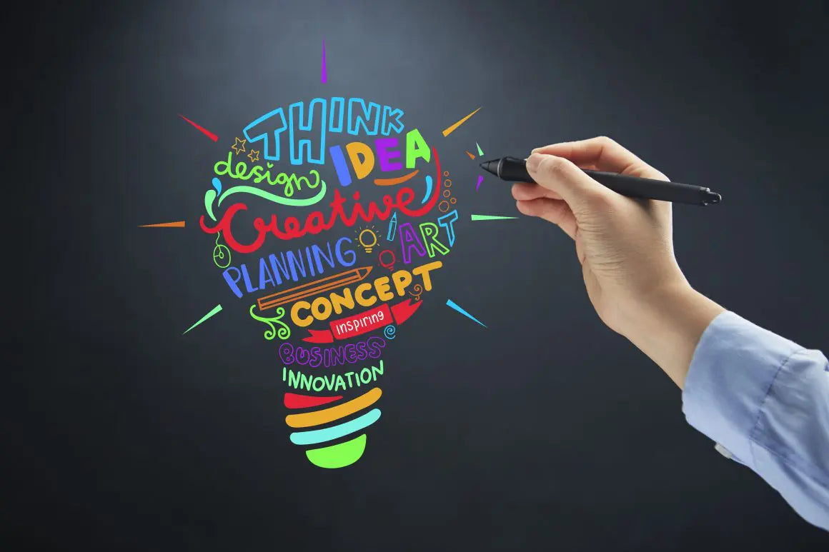 Creative idea and business innovation concept illustrated with a colorful lightbulb and design planning words